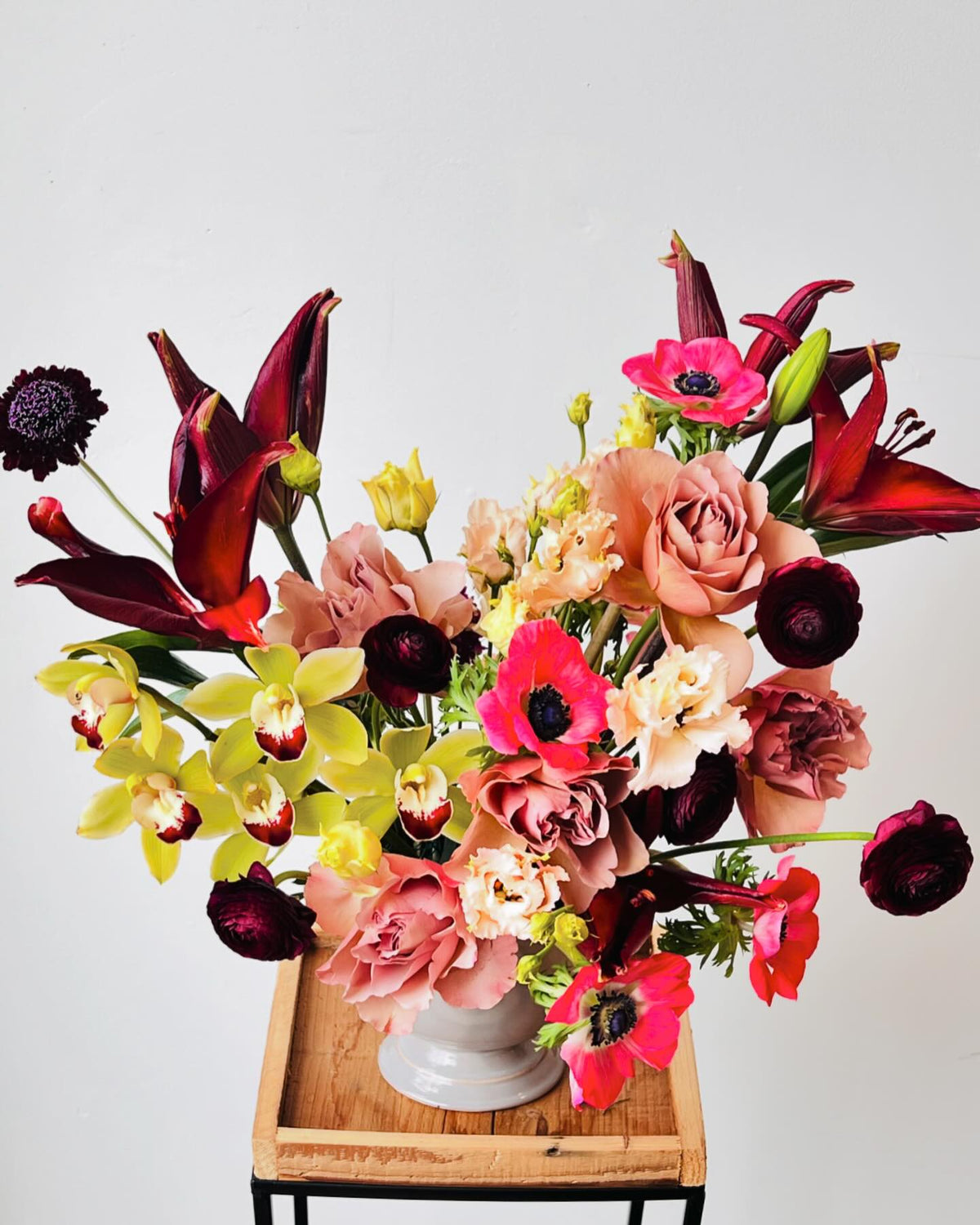 Close-up of zinnias, roses and blue delphinium wedding flowers
