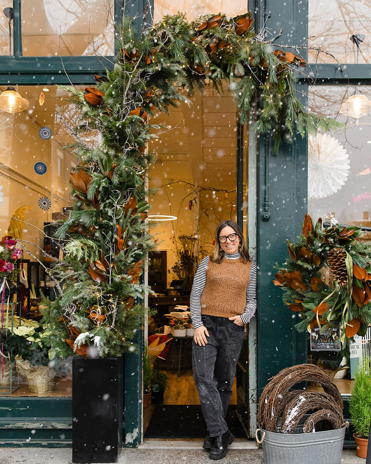 Floral designer Rebecca Scheller beside one of her floral installations