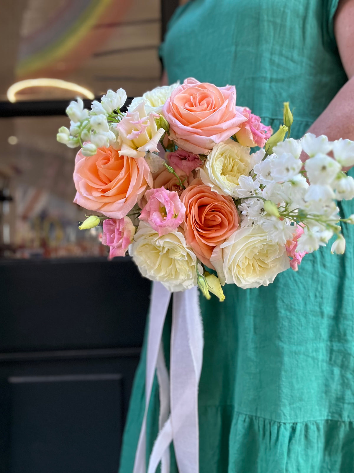 Protea and hellebore wedding boutonnieres on a woven chair