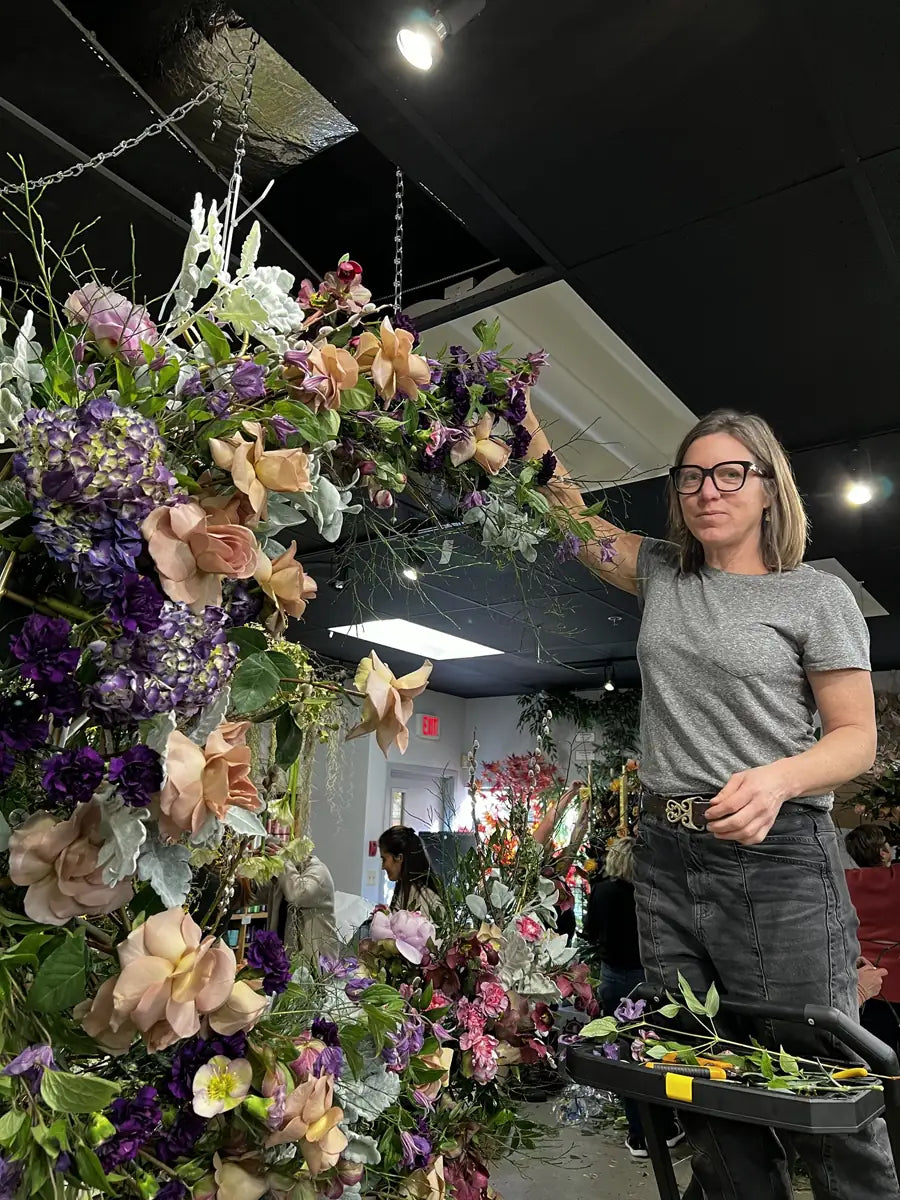 Suspended fresh floral installation of roses, hydrangea and clematis