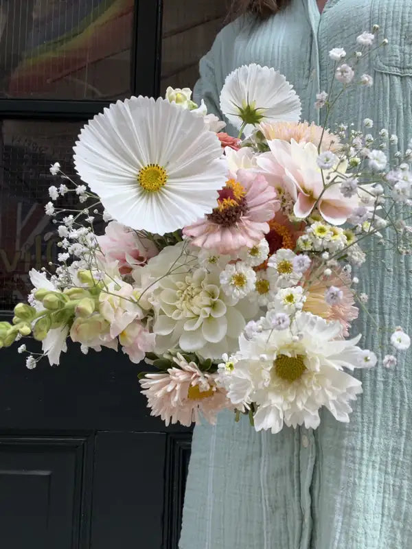 Airy white cosmos and blush dahlia wedding bouquet with baby's breath